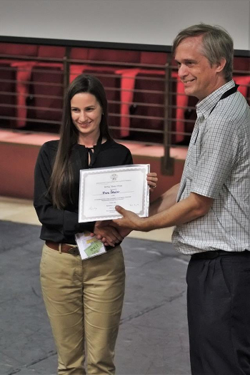 Slika: Član komisije prof. dr. Philip Jessop, eden izmed vodilnih kanadskih raziskovalcev na področju zelene kemije, podeljuje priznanje Klari Čebular.